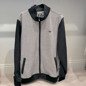 Travis Mathew full zip up jacket. Wind breaker material. Size Large